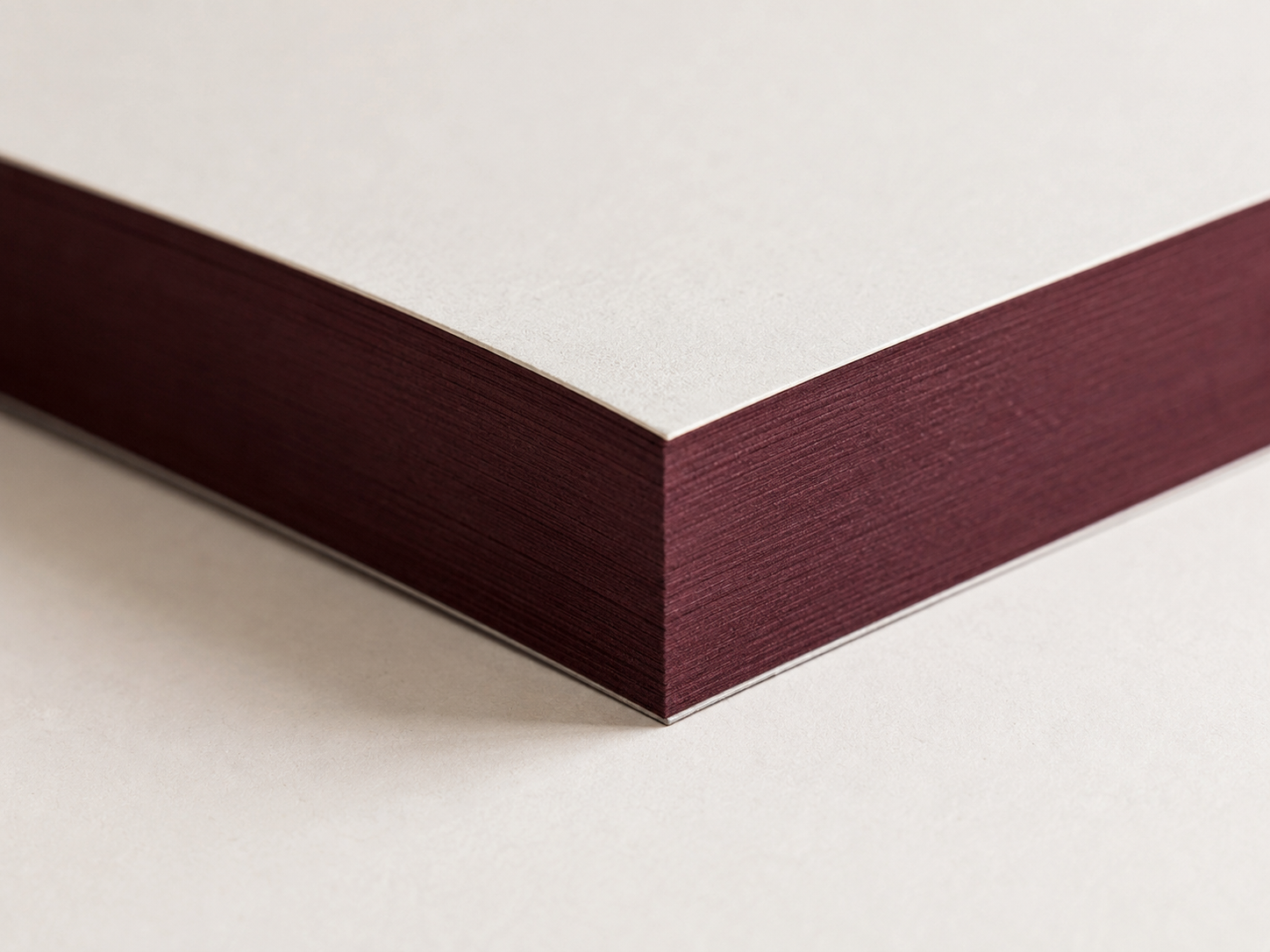 Close view of burgundy ink-finished page edge.