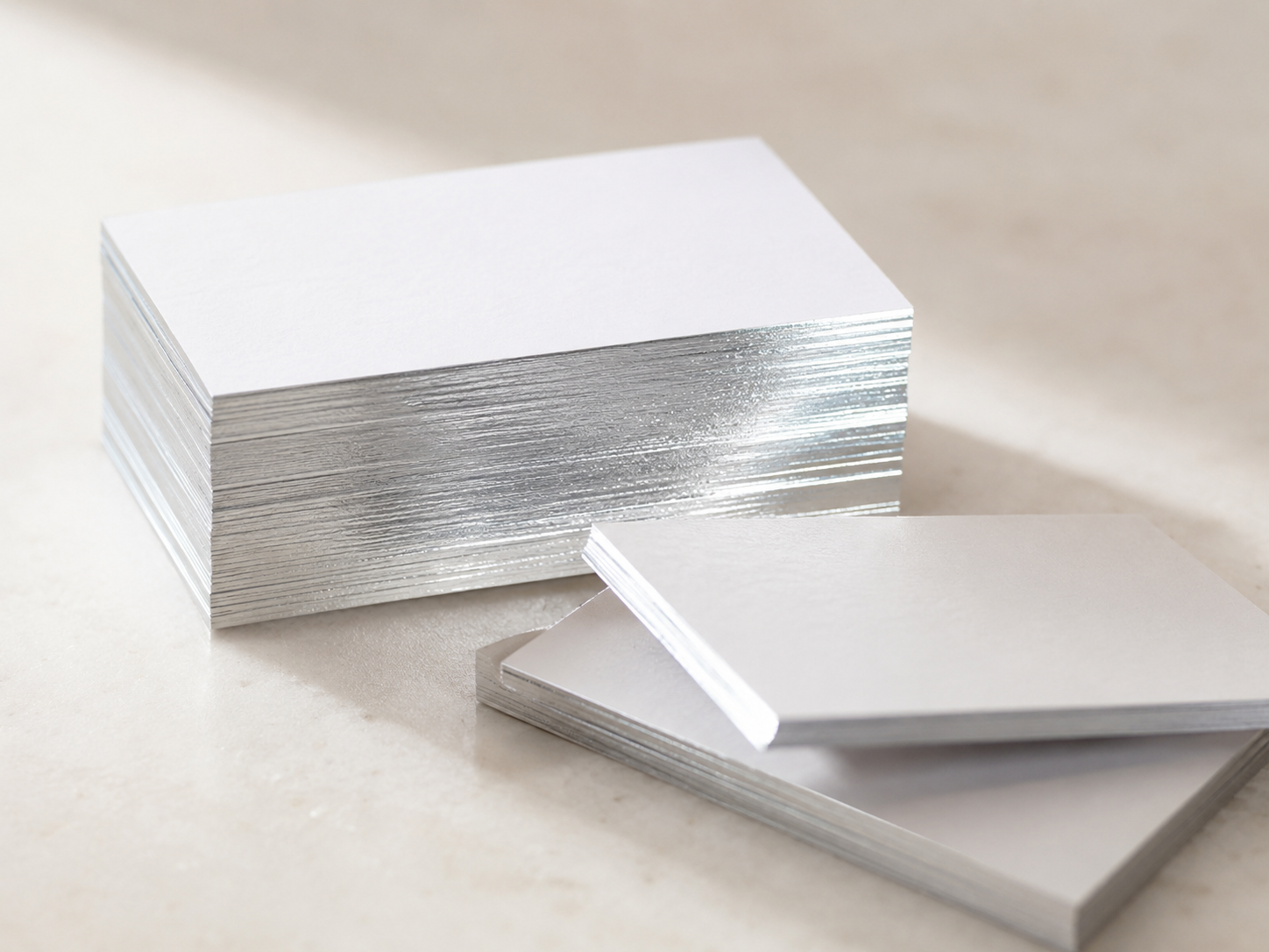 Stack of cards with silver foil-finished edges.
