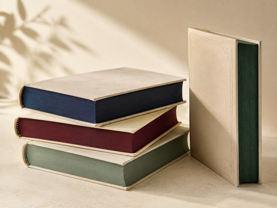 Books with navy, burgundy, and green ink-edged pages.