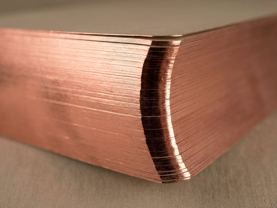 Copper foil edge gilding on a book corner.