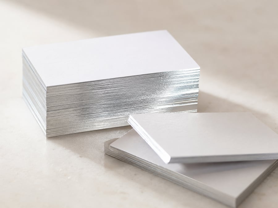 Silver foil gilded edges on stacked cards.